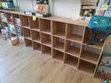 a book shelf with books and a backpack on it