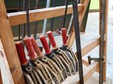 a lot of tools that are hanging on a rack