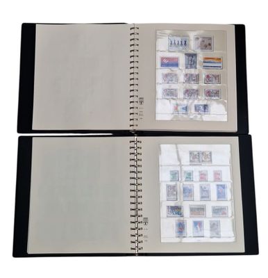 two pages of a book with stamps on them on a white surface