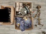 a box of assorted items sitting on a wooden floor