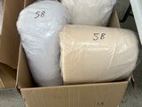 a cardboard box full of toilet paper and rolls of toilet paper