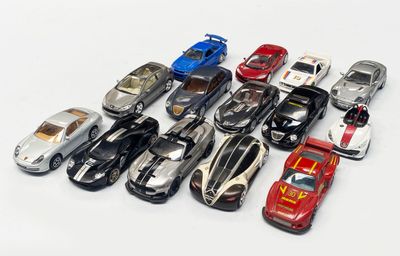 a lot of toy cars that are on a white surface