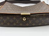 a close up of a louis vuitton bag on a table