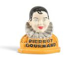 a figurine of a woman with a clown ' s head on it