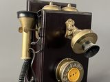 an old fashioned telephone that is on display on the table