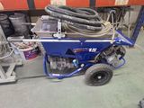 a blue cart with a hose attached to it in a warehouse