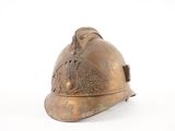 a bronze fireman ' s helmet on a white background