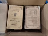 two books in a cardboard box on the floor