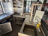 a kitchen with a sink and a refrigerator in it