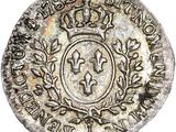 a silver coin with a crown on top of it