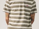 the man is wearing a striped t - shirt and blue jeans