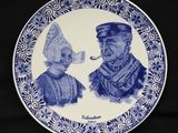une assiette bleue et blanche sur laquelle sont représentés un homme et une femme