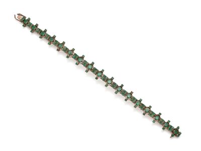 a close up of a bracelet with green stones on a white background