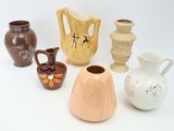 many different vases that are sitting on a table