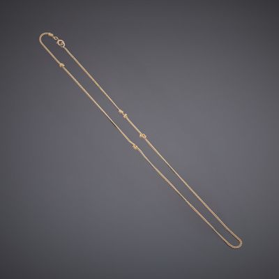 a gold necklace with a star design on it