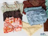 many different types of clothes laid out on a table