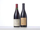 two bottles of wine sit side by side on a table