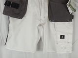 a pair of white shorts hanging on a hanger on a wall