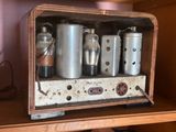 a wooden shelf with a bunch of metal containers on it