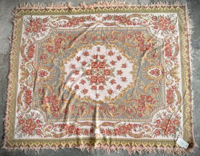 an old rug with a floral design on it