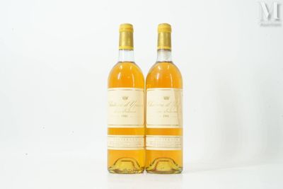 two bottles of wine sitting next to each other on a white surface