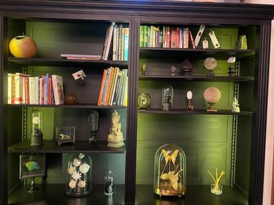 a bookcase with many books on it in a room
