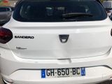 a white car parked in a parking lot next to other cars
