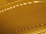 the inside of a tan leather purse with a white stitching on it