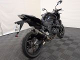 a black motorcycle that is parked on a checkered floor