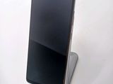 the back view of a black cell phone sitting on top of a white table