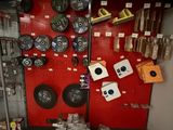 a red wall with various items on it in a store