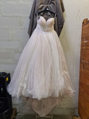a dress hanging on a mannequin in a room
