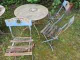 a table and chairs in the grass near a table and chairs