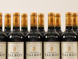 several bottles of red wine are lined up in a row