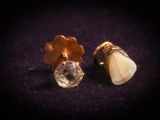 two pieces of gold and white stone are sitting on a purple surface