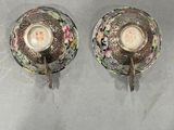 pair of silver and floral teacups on a white background