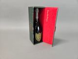 a bottle of wine in a red box on a table