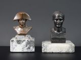 deux statues représentant un homme et une femme, posées sur des blocs de marbre
