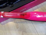 a pink toothbrush that is sitting on a table