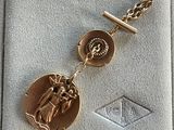 an image of a gold medal with a chain around it