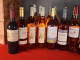 several bottles of wine are lined up in a row on a table