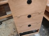 a picture of a wooden dresser with three drawers