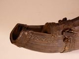 a brown shoe that is sitting on a white surface