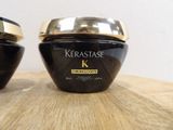 two jars of kerastase cream on a wooden table
