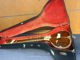 a guitar in a case sitting on the floor