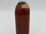 a bottle of liquor sitting on top of a white surface