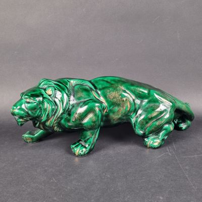 a close up of a green statue of a lion on a gray background