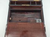 a small wooden box with a drawer on top of it