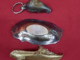 two silver spoons and a silver spoon on a red cloth