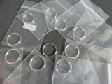 a lot of clear plastic bags with silver rings on them